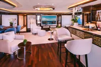 Luxurious interior of a 2008 Benetti Custom yacht with elegant seating and bar area.