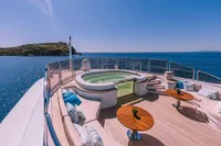Luxurious 2008 Benetti Custom yacht deck with jacuzzi and ocean view.