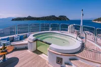 Luxurious 2008 Benetti Custom yacht deck with jacuzzi, ocean view, and elegant seating area.
