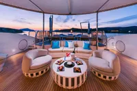 Luxurious 2008 Benetti Custom yacht deck with elegant seating and sunset view.
