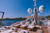 Luxurious 2008 Benetti Custom yacht deck with sun loungers and ocean view.