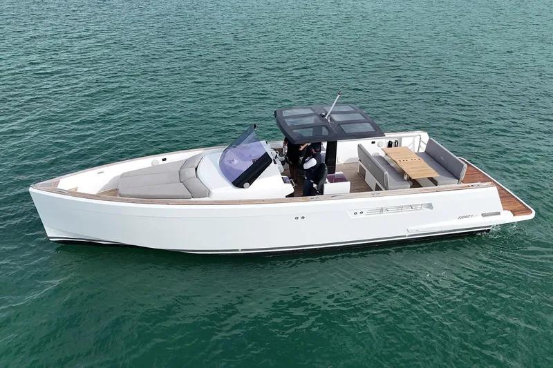  Yacht Photos Pics 2013 Fjord 40' Open yacht on calm water, featuring sleek design and spacious deck.