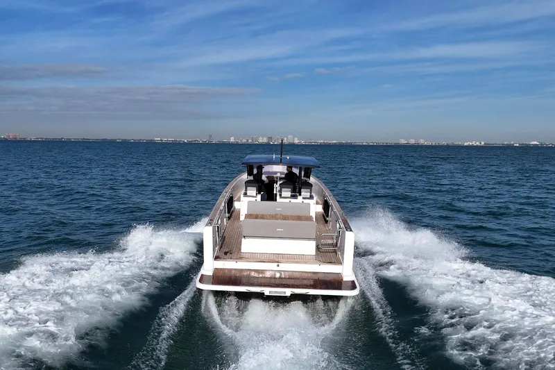  Yacht Photos Pics 2013 Fjord 40' Open yacht cruising on open water under clear skies.