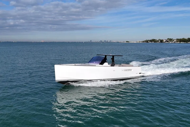  Yacht Photos Pics 2013 Fjord 40' Open yacht cruising on a calm sea under a partly cloudy sky.