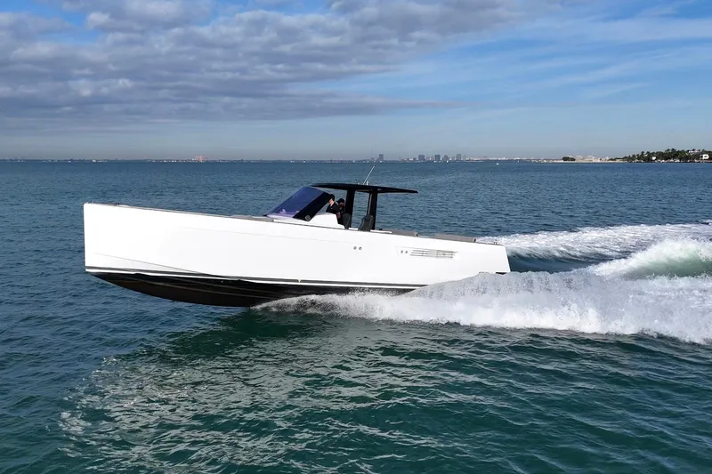  Yacht Photos Pics 2013 Fjord 40' Open yacht cruising on open water under a partly cloudy sky.