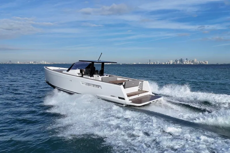  Yacht Photos Pics 2013 Fjord 40' Open yacht cruising on ocean with city skyline in background.