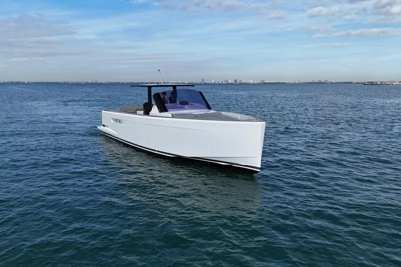  Yacht Photos Pics 2013 Fjord 40' Open yacht cruising on calm blue waters under a partly cloudy sky.