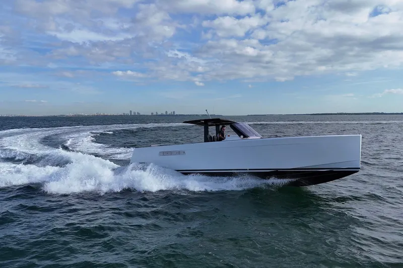  Yacht Photos Pics 2013 Fjord 40' Open yacht cruising on open water under a partly cloudy sky.