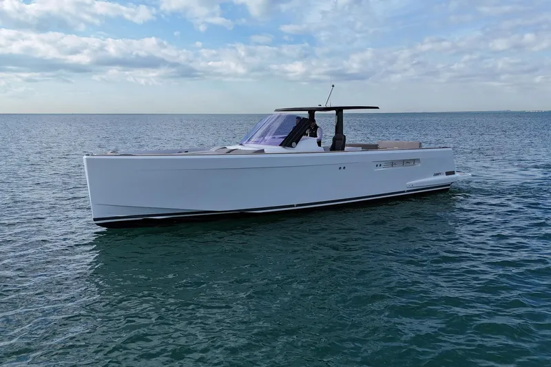  Yacht Photos Pics 2013 Fjord 40' Open yacht cruising on calm ocean waters under a cloudy sky.