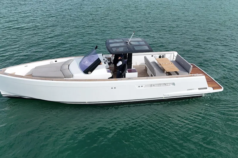  Yacht Photos Pics 2013 Fjord 40' Open yacht cruising on calm waters, featuring sleek design and spacious deck.