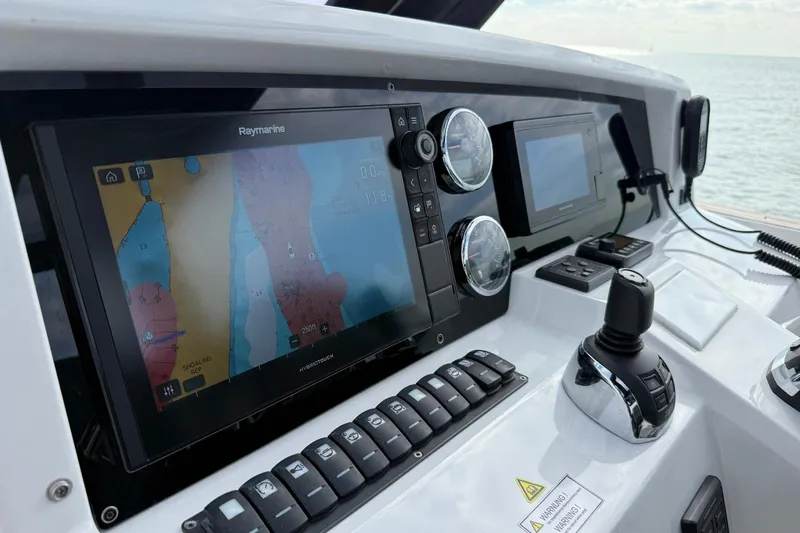  Yacht Photos Pics Control panel of a 2013 Fjord 40' Open boat with navigation screens.