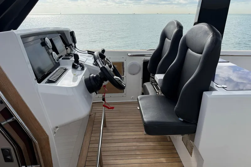  Yacht Photos Pics Helm of 2013 Fjord 40' Open yacht with dual seats and navigation controls.