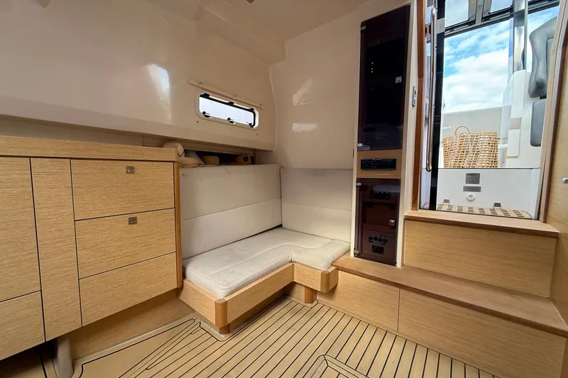  Yacht Photos Pics Interior of 2013 Fjord 40' Open yacht with wooden cabinetry and cushioned seating.