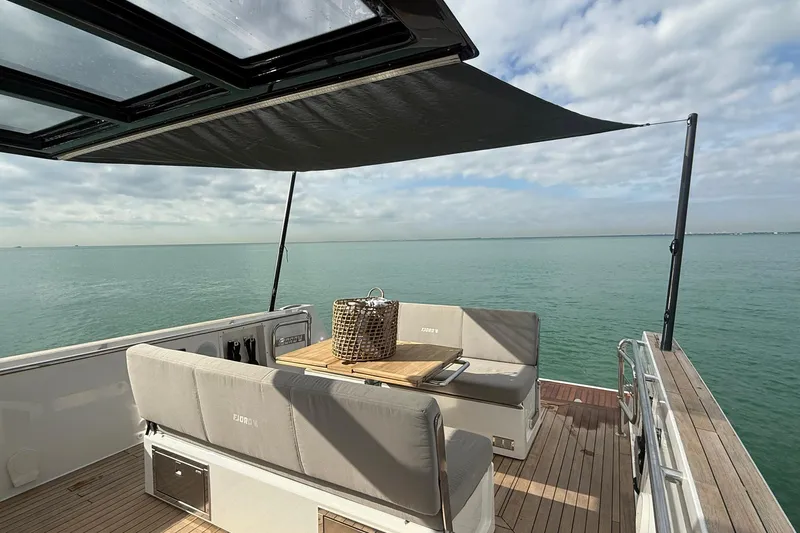  Yacht Photos Pics 2013 Fjord 40' Open yacht deck with seating, table, and ocean view.