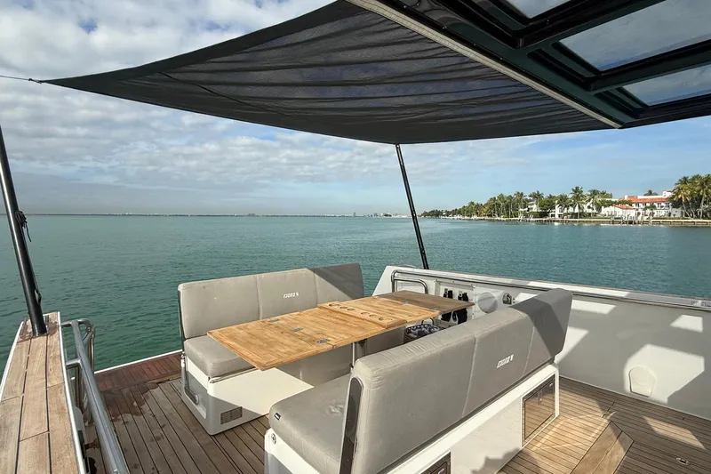  Yacht Photos Pics Luxurious 2013 Fjord 40' Open yacht with shaded deck and scenic waterfront view.