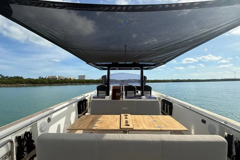  Yacht Photos Pics 2013 Fjord 40' Open yacht with sunshade, wooden table, and scenic water view.