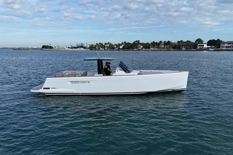  Yacht Photos Pics 2013 Fjord 40' Open yacht cruising on calm waters under a partly cloudy sky.