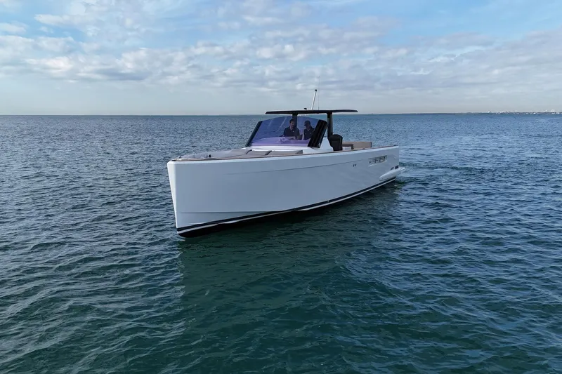  Yacht Photos Pics 2013 Fjord 40' Open yacht cruising on calm ocean waters under a cloudy sky.