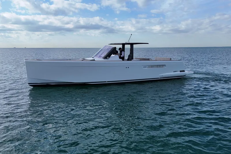  Yacht Photos Pics 2013 Fjord 40' Open yacht cruising on calm ocean waters under a cloudy sky.