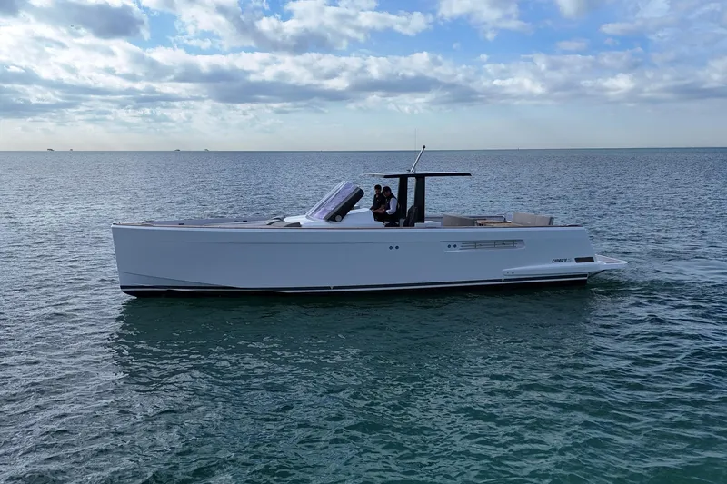  Yacht Photos Pics 2013 Fjord 40' Open yacht cruising on calm ocean waters under a partly cloudy sky.