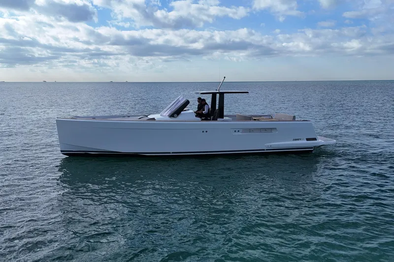  Yacht Photos Pics 2013 Fjord 40' Open yacht cruising on calm ocean waters under a partly cloudy sky.