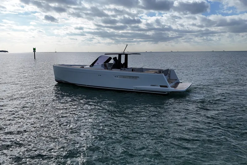  Yacht Photos Pics 2013 Fjord 40' Open yacht cruising on calm ocean waters under cloudy sky.