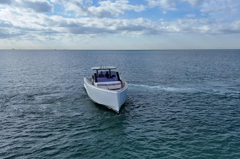  Yacht Photos Pics 2013 Fjord 40' Open yacht cruising on open sea under cloudy sky.