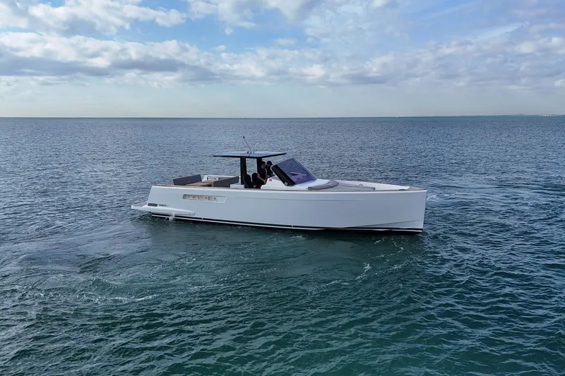  Yacht Photos Pics 2013 Fjord 40' Open yacht cruising on calm ocean waters under a partly cloudy sky.