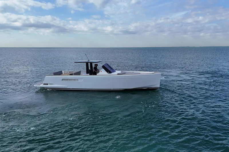  Yacht Photos Pics 2013 Fjord 40' Open yacht cruising on calm ocean waters under a partly cloudy sky.