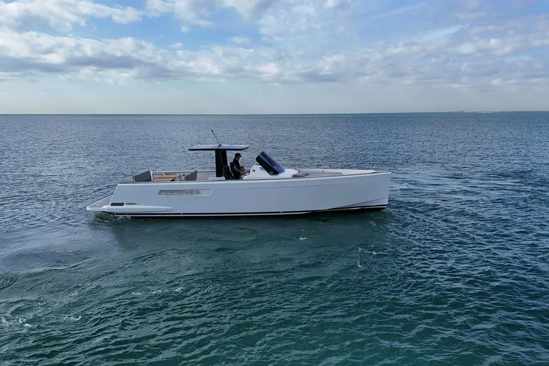  Yacht Photos Pics 2013 Fjord 40' Open yacht cruising on calm ocean waters under a cloudy sky.