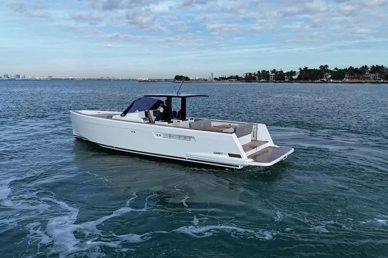  Yacht Photos Pics 2013 Fjord 40' Open yacht cruising on calm waters under a partly cloudy sky.