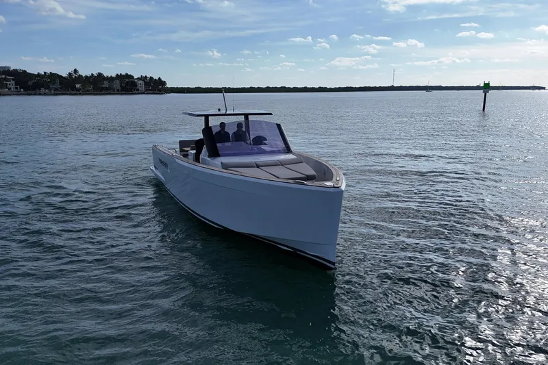  Yacht Photos Pics 2013 Fjord 40' Open boat cruising on calm waters under a clear sky.