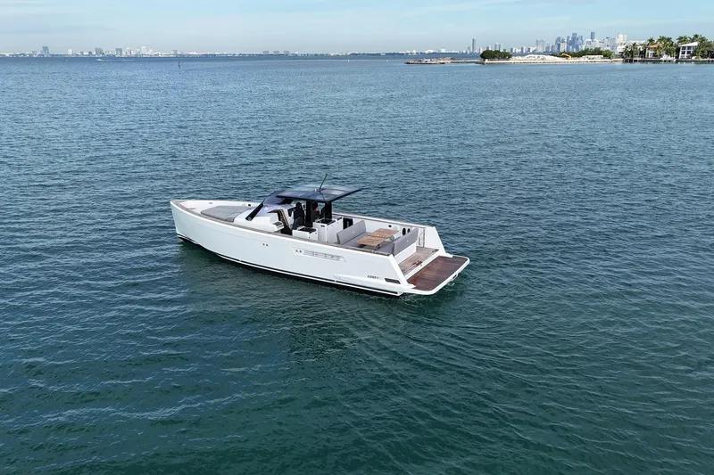  Yacht Photos Pics 2013 Fjord 40' Open yacht cruising on calm waters near a distant city skyline.