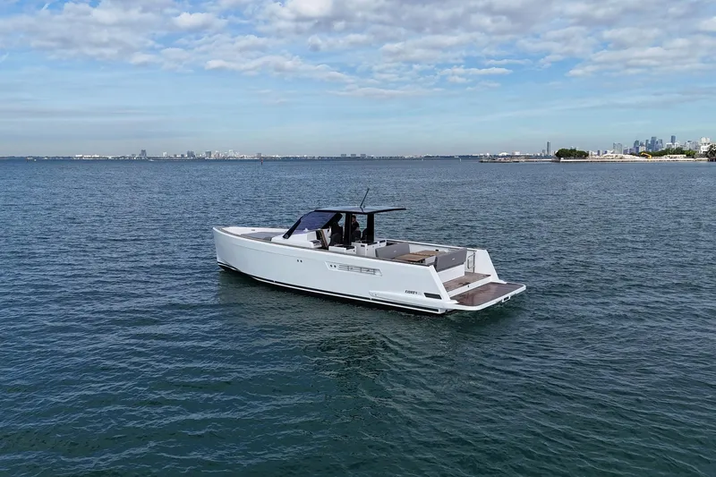  Yacht Photos Pics 2013 Fjord 40' Open yacht cruising on calm waters under a partly cloudy sky.