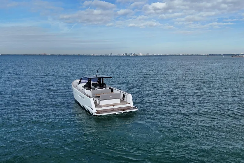  Yacht Photos Pics 2013 Fjord 40' Open yacht cruising on calm ocean waters under a partly cloudy sky.