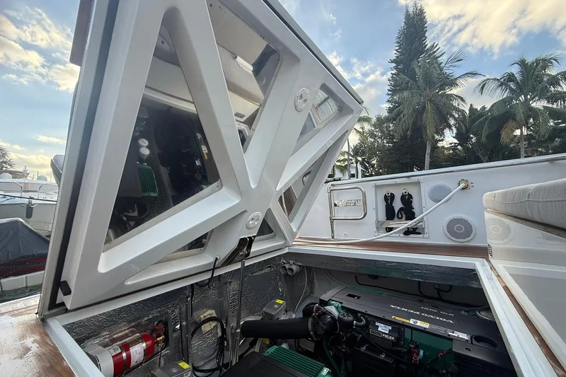  Yacht Photos Pics Engine compartment of a 2013 Fjord 40' Open yacht with open hatch, surrounded by palm trees.