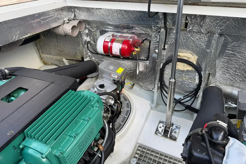  Yacht Photos Pics Engine compartment of a 2013 Fjord 40' Open boat, featuring a fire extinguisher and insulation.