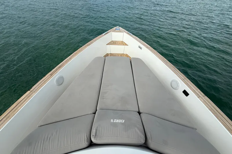  Yacht Photos Pics Bow view of 2013 Fjord 40' Open yacht with cushioned seating on calm water.
