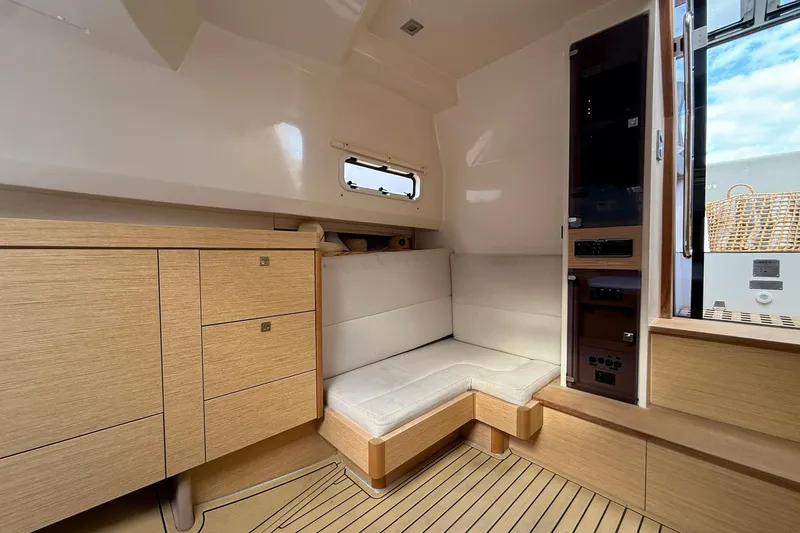  Yacht Photos Pics Interior of 2013 Fjord 40' Open yacht with modern wood cabinetry and seating.