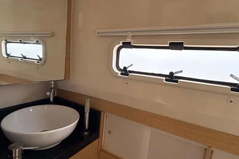  Yacht Photos Pics Bathroom interior of 2013 Fjord 40' Open yacht with modern sink and window.
