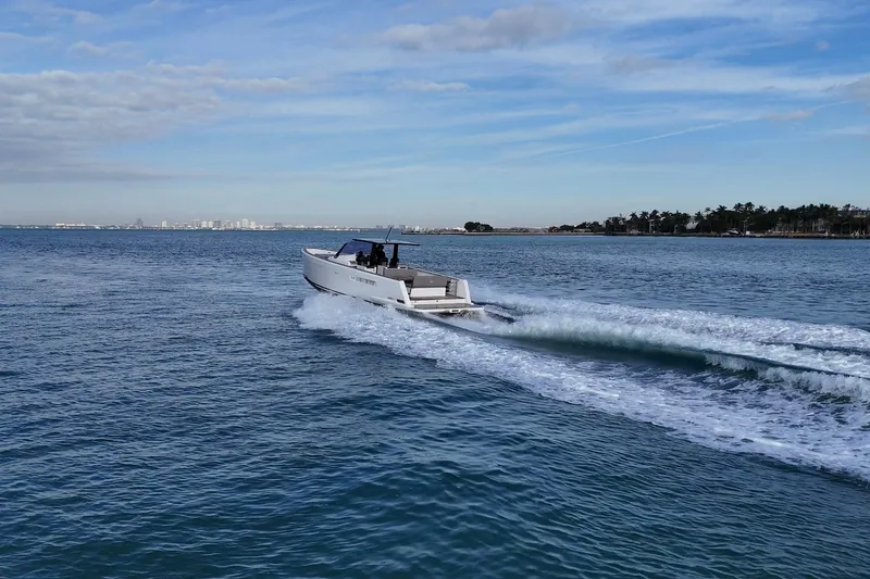  Yacht Photos Pics 2013 Fjord 40' Open yacht cruising on open water under a blue sky.