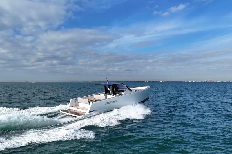  Yacht Photos Pics 2013 Fjord 40' Open yacht cruising on open water under a blue sky.