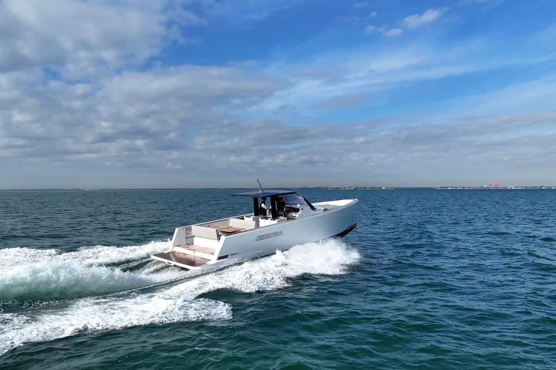  Yacht Photos Pics 2013 Fjord 40' Open yacht cruising on open water under a blue sky.