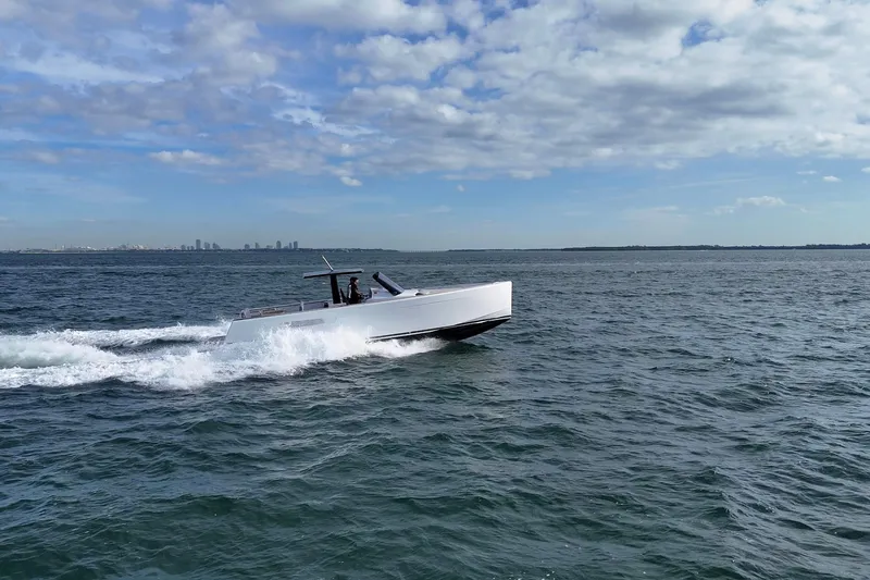  Yacht Photos Pics 2013 Fjord 40' Open yacht cruising on open water under a partly cloudy sky.