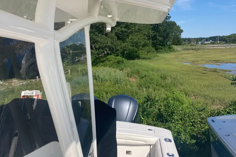  Yacht Photos Pics 2018 Regulator 28 Center Console boat with Optimus 360 Joystick, near lush greenery.