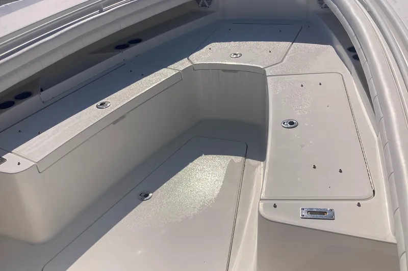  Yacht Photos Pics 2018 Regulator 28 Center Console boat deck with storage compartments and seating area.