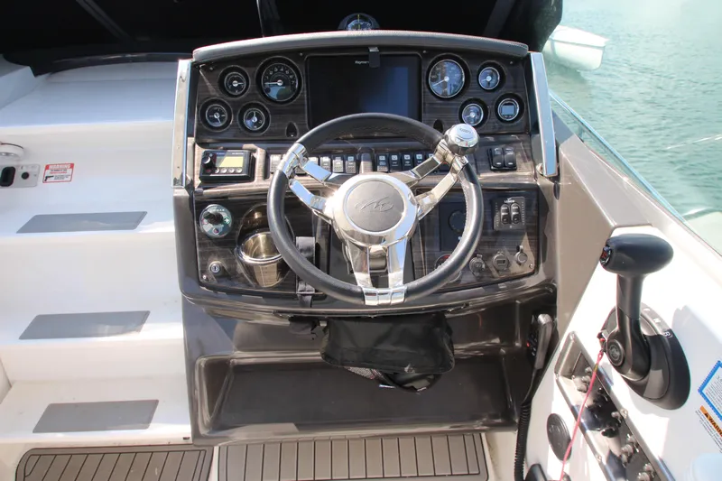  Yacht Photos Pics Cockpit of 2018 Monterey 295 Sport Yacht with steering wheel and control panel.