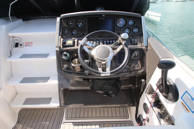  Yacht Photos Pics Cockpit of 2018 Monterey 295 Sport Yacht with steering wheel and control panel.
