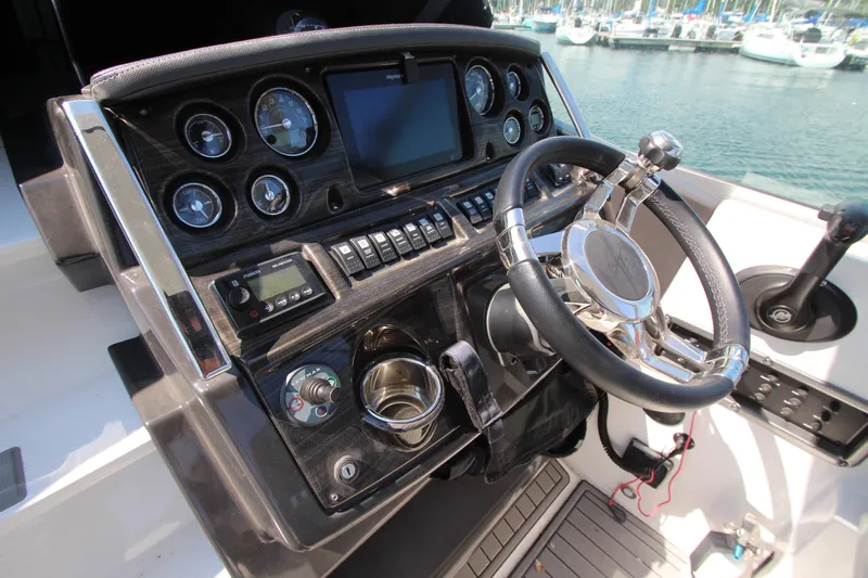 Yacht Photos Pics Cockpit of 2018 Monterey 295 Sport Yacht with steering wheel and control panel.