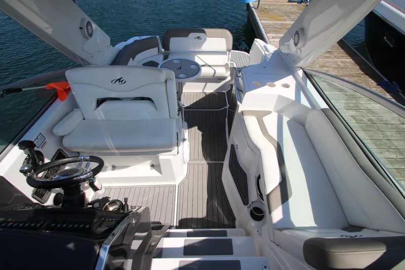  Yacht Photos Pics 2018 Monterey 295 Sport Yacht interior with white seating and sleek design at dock.